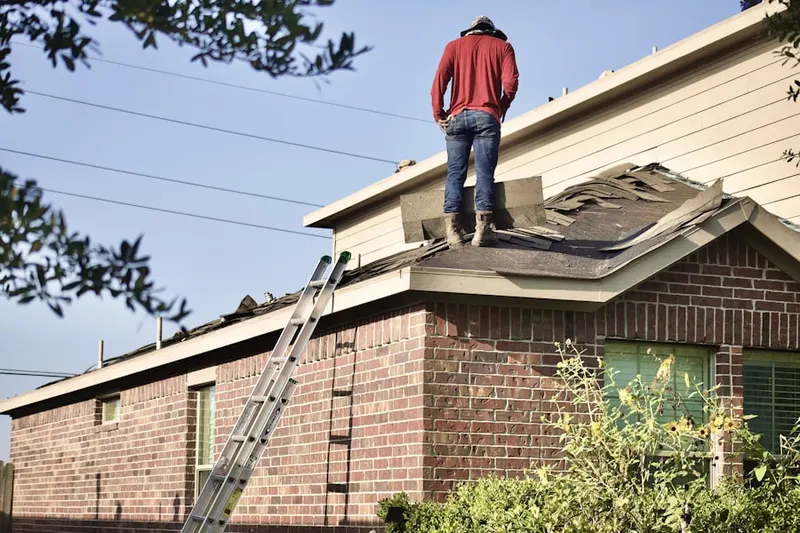 Professional roofer working on a residential roof in Washington Mall